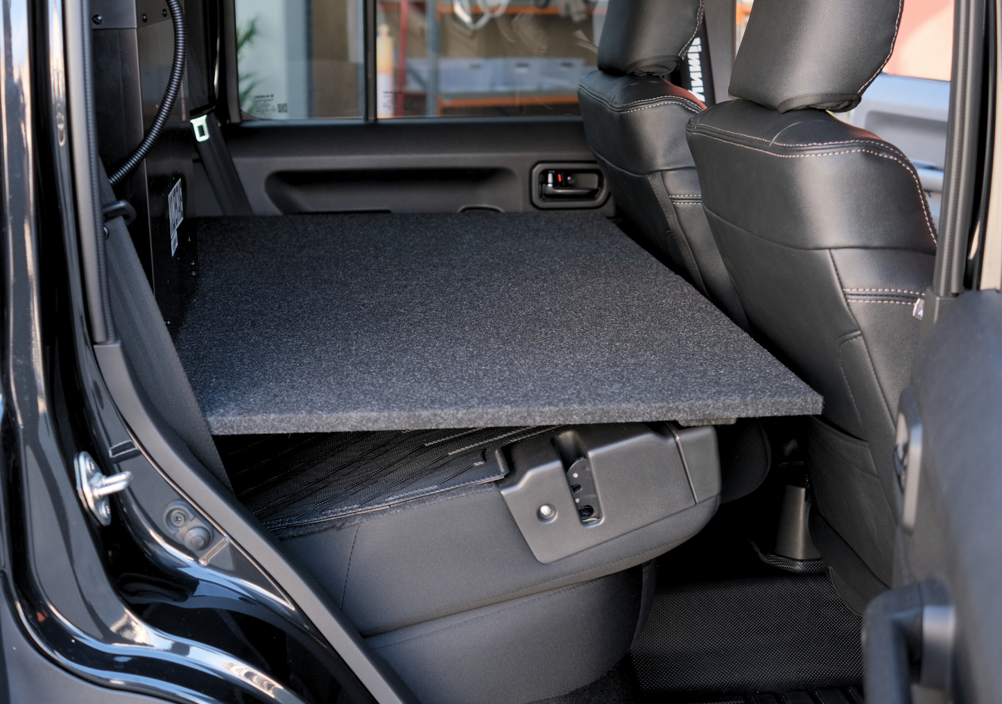 EXPLOREJIMNY jimny xl drawer system installed in black vehicle interior with seats and carpeted storage surface